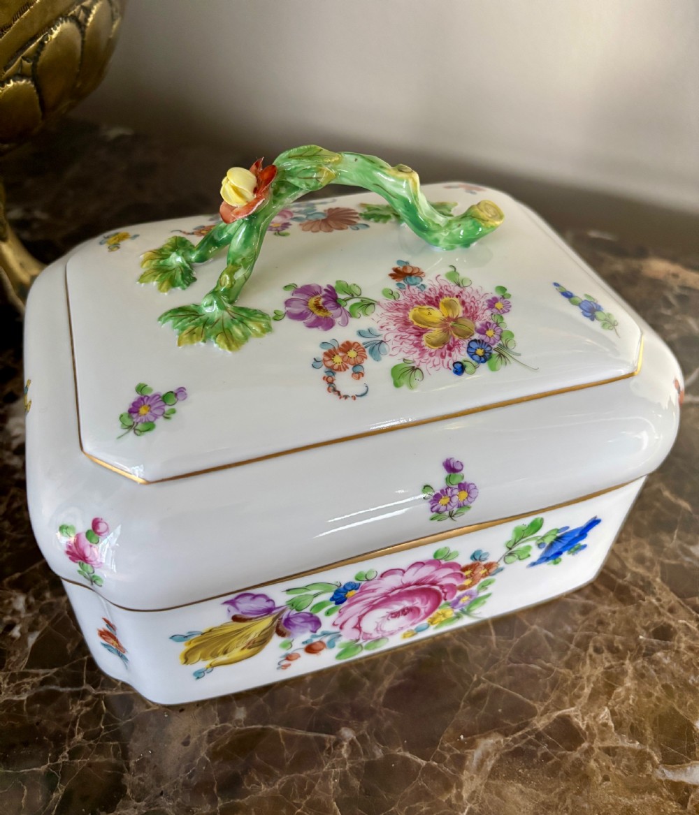 A rectangular white porcelain sugar box decorated with hand-painted flowers, gilded borders, and a green branch handle on the cover. View II