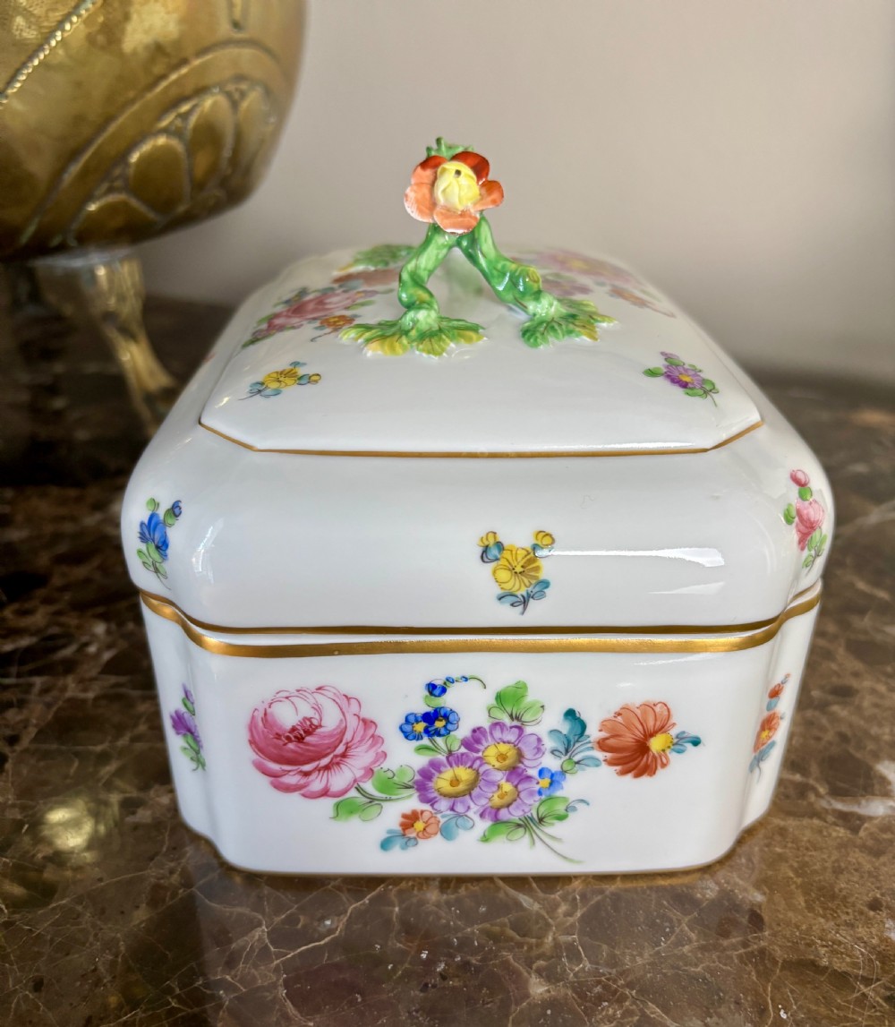 A rectangular white porcelain sugar box decorated with hand-painted flowers, gilded borders, and a green branch handle on the cover. View III