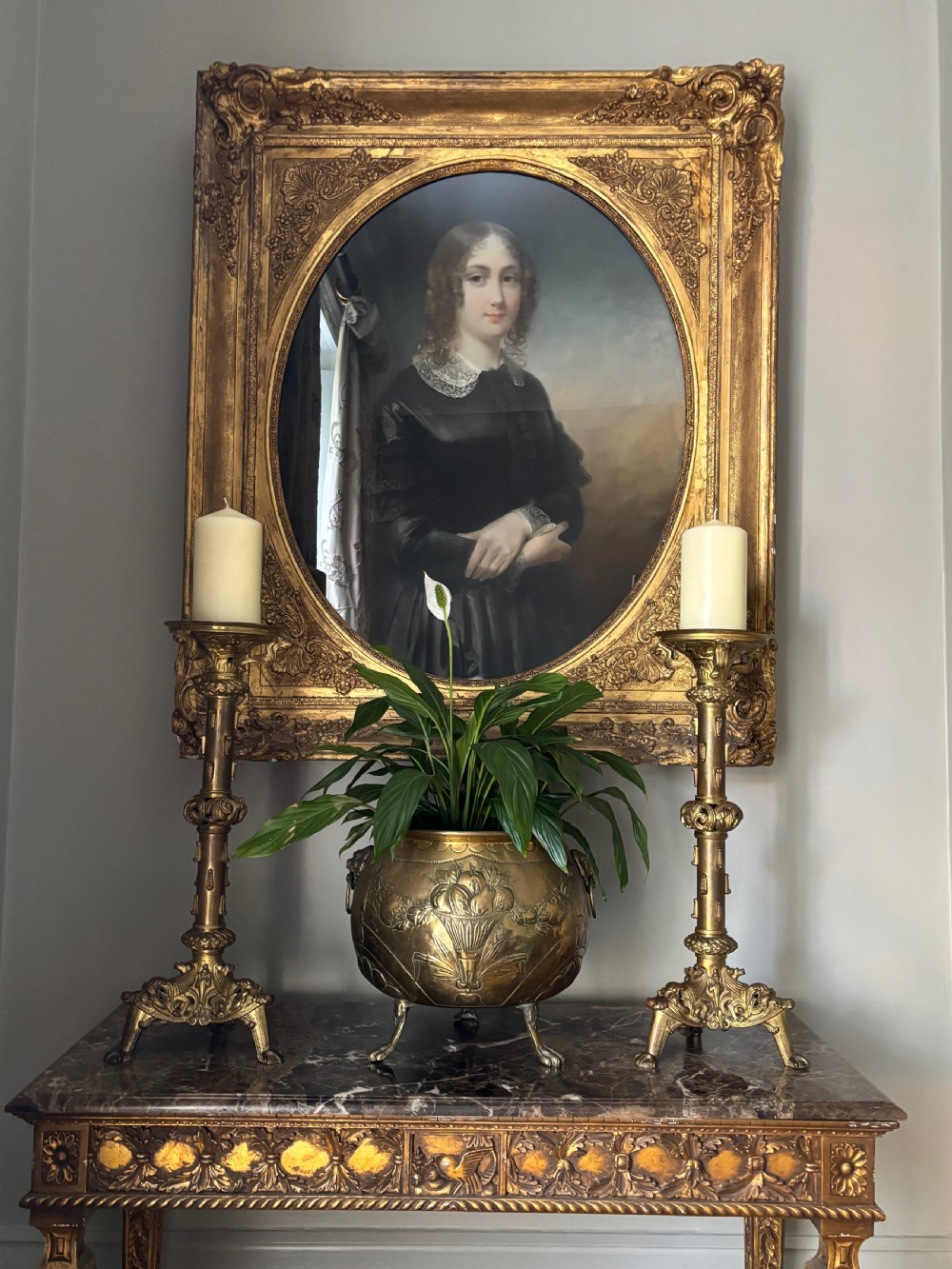 A pair of large French 19th-century gilt bronze candlesticks featuring ornate tripod bases, detailed knapped columns, and wide drip pans. View VI