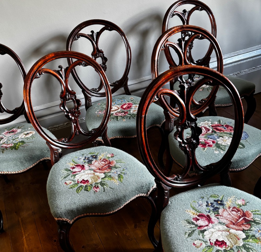 A set of six Victorian rosewood dining chairs with carved balloon backs and duck egg blue needlepoint floral seats. View IV