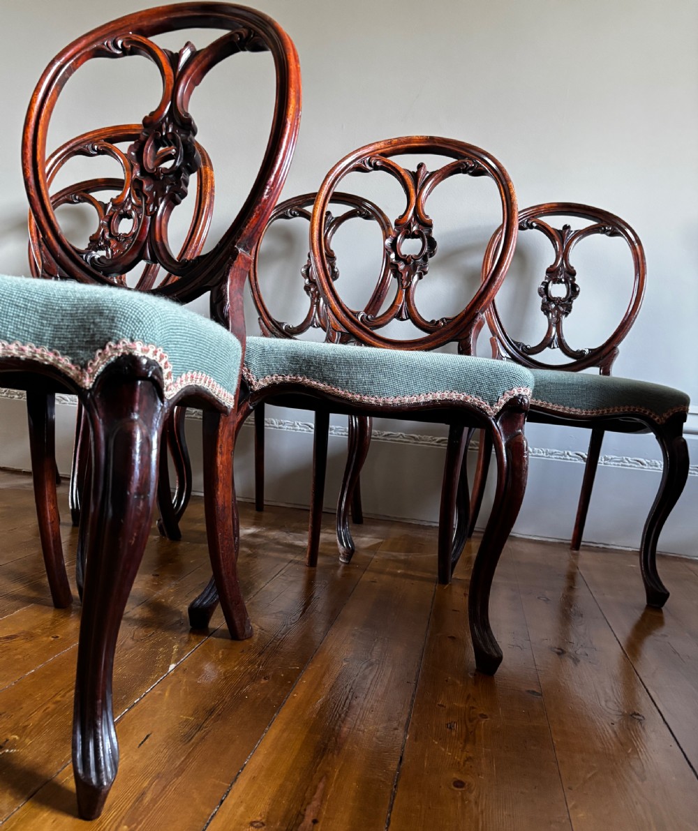 A set of six Victorian rosewood dining chairs with carved balloon backs and duck egg blue needlepoint floral seats. View V