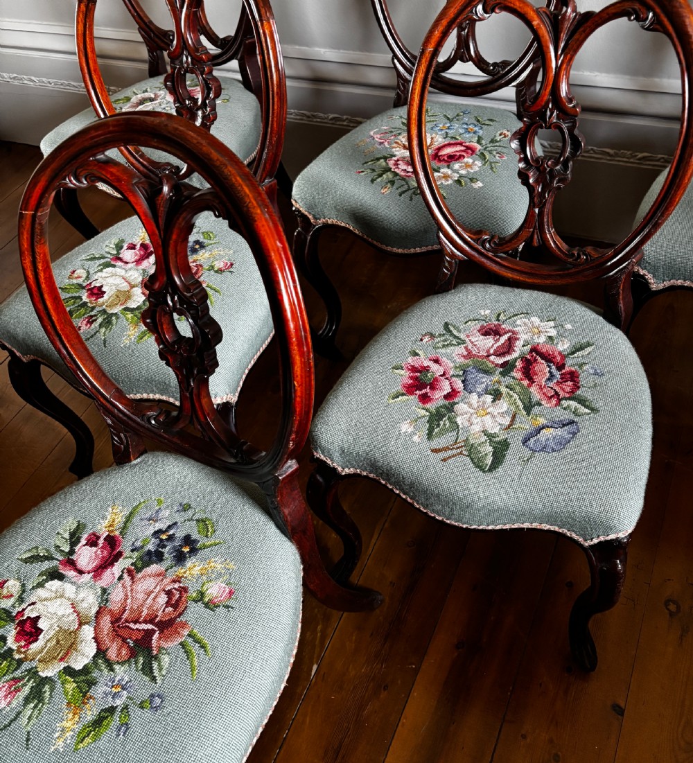 A set of six Victorian rosewood dining chairs with carved balloon backs and duck egg blue needlepoint floral seats. View VI
