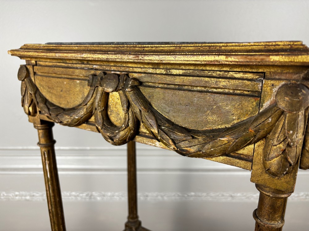 An antique French Empire two-tiered giltwood jardiniere stand featuring carved festoon swags, fluted column legs, and a lower caned planter containing a metal liner. View VIII