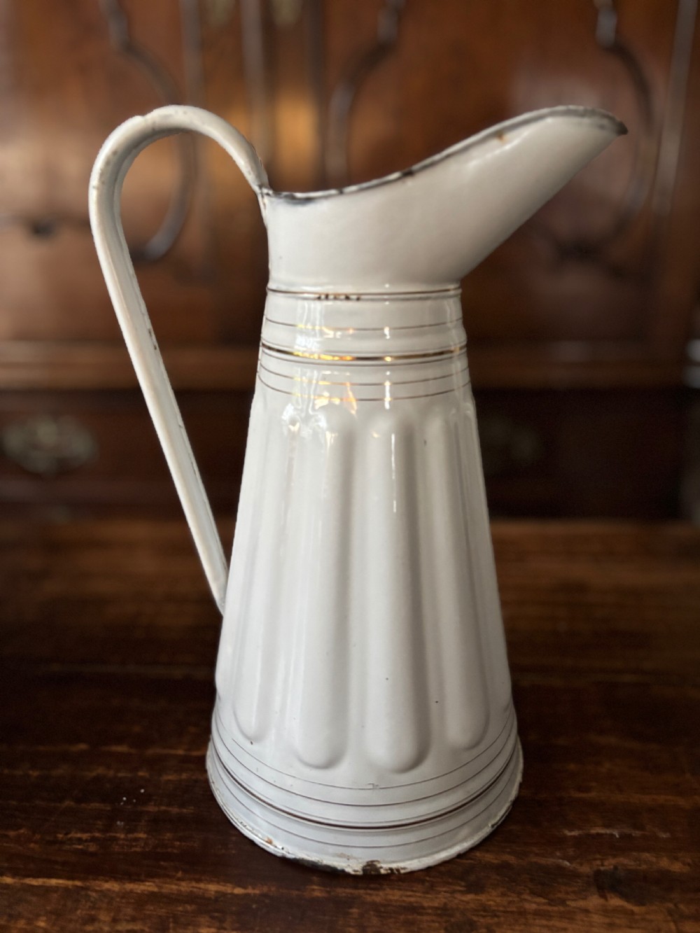 A tall white French enamelware water jug featuring a fluted lower body, thin gold gilt line details, an arched handle, and a raised spout. View III