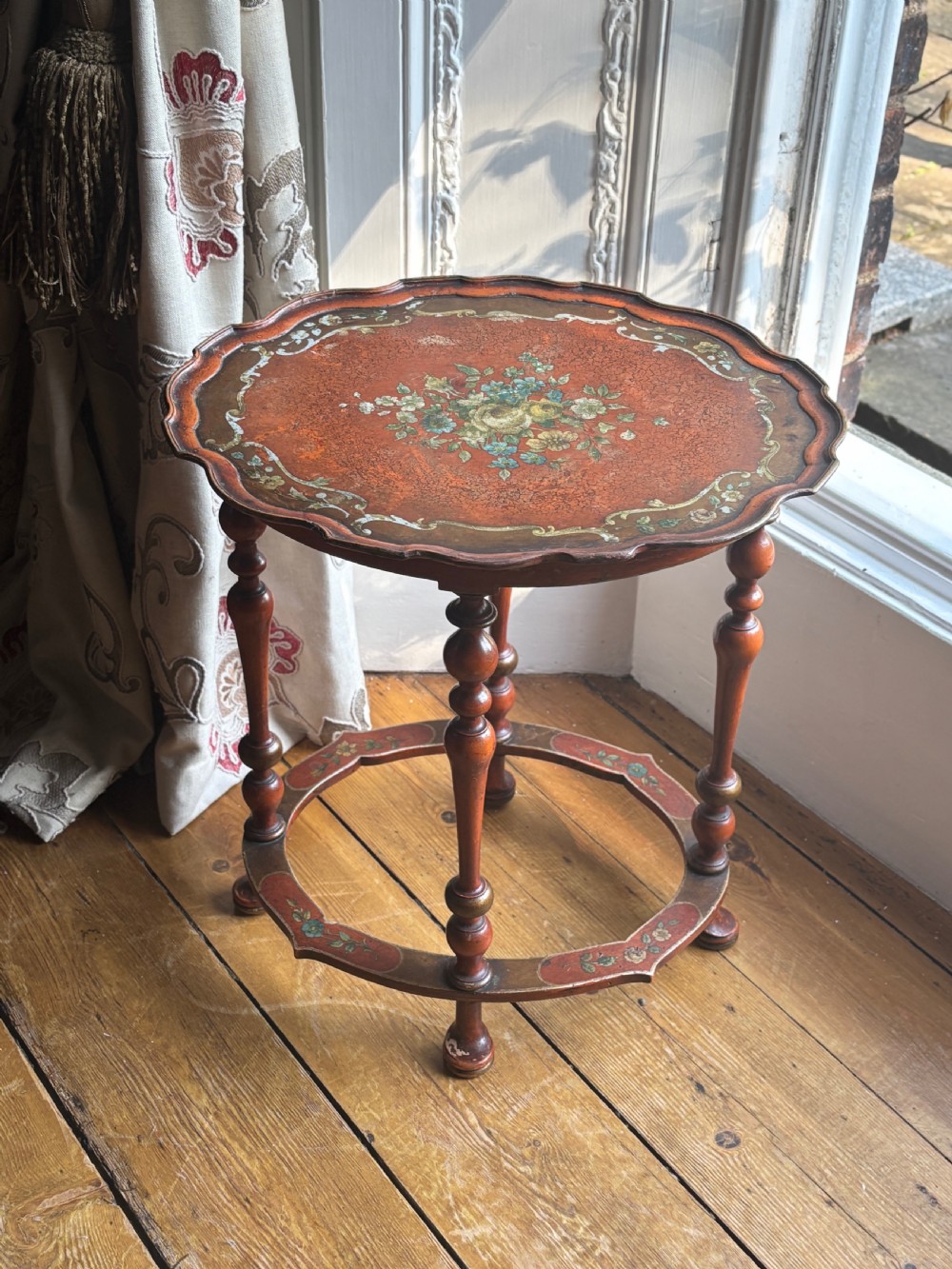 A late nineteenth-century Italian polychrome occasional table with a scalloped tray top, central painted floral design, turned legs, and an oval stretcher. View III