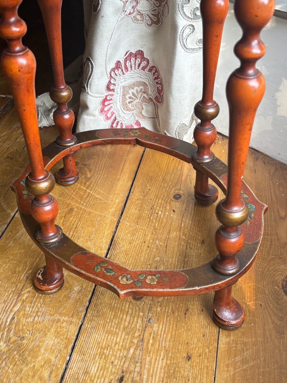 A late nineteenth-century Italian polychrome occasional table with a scalloped tray top, central painted floral design, turned legs, and an oval stretcher. View V