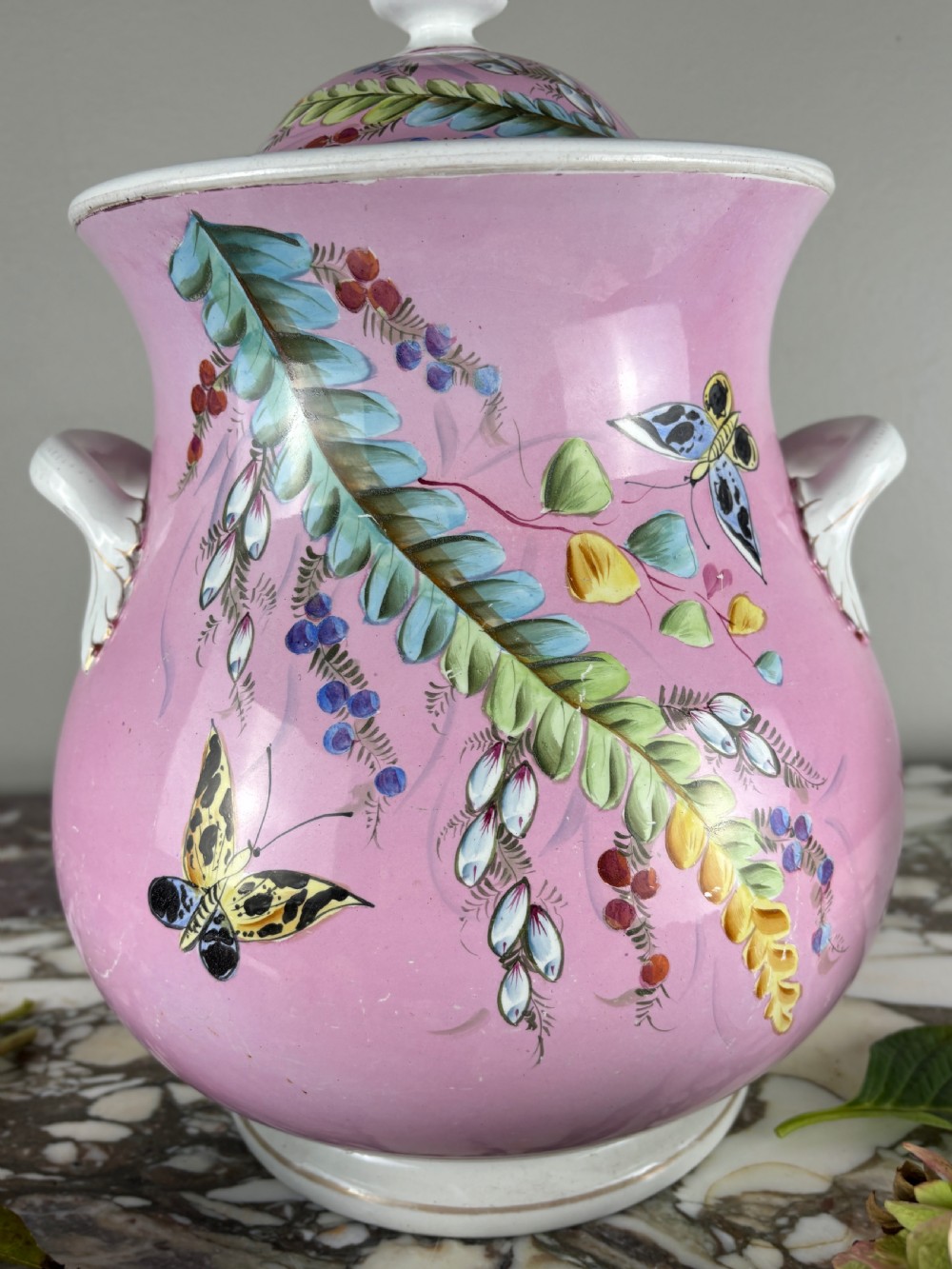 A Victorian Minton ceramic lidded pail featuring hand-painted butterflies and botanical foliage over a pink ground with twin white handles. View IV
