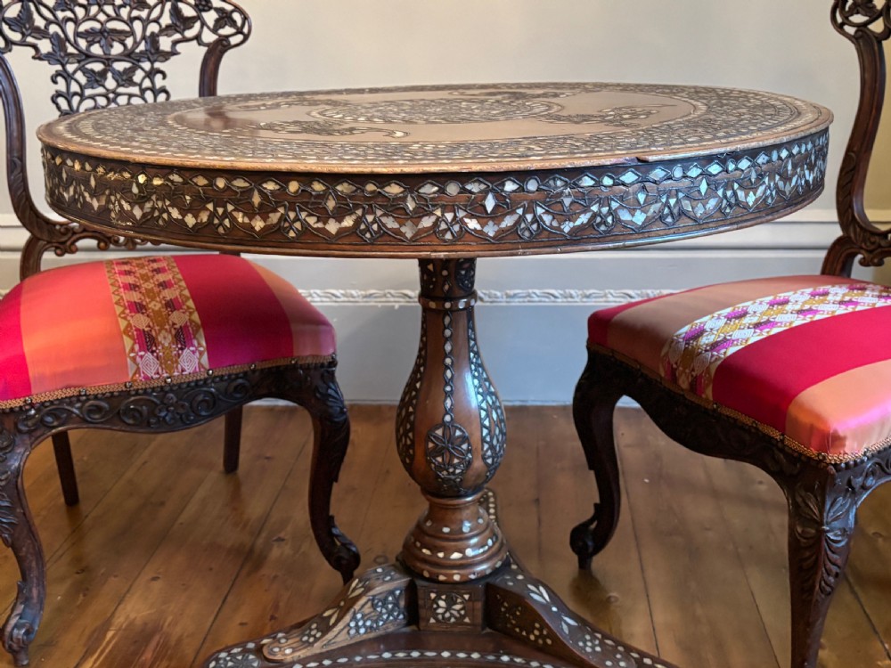 A 19th-century round Anglo-Indian pedestal table featuring mother-of-pearl inlay across the circular top, apron, turned column, and tripod base. View III