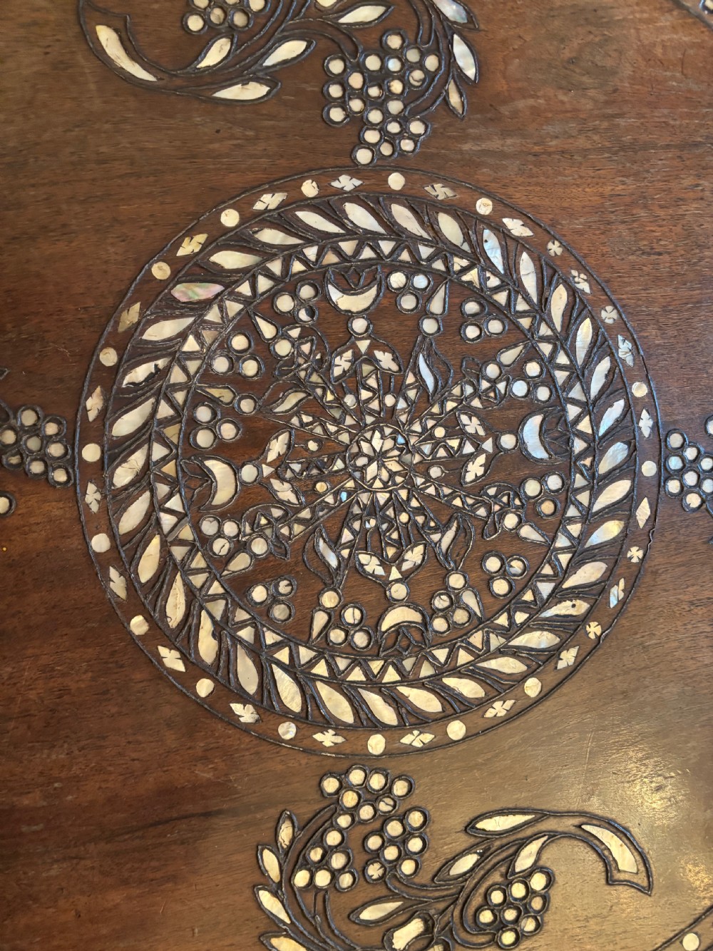 A 19th-century round Anglo-Indian pedestal table featuring mother-of-pearl inlay across the circular top, apron, turned column, and tripod base. View VIII