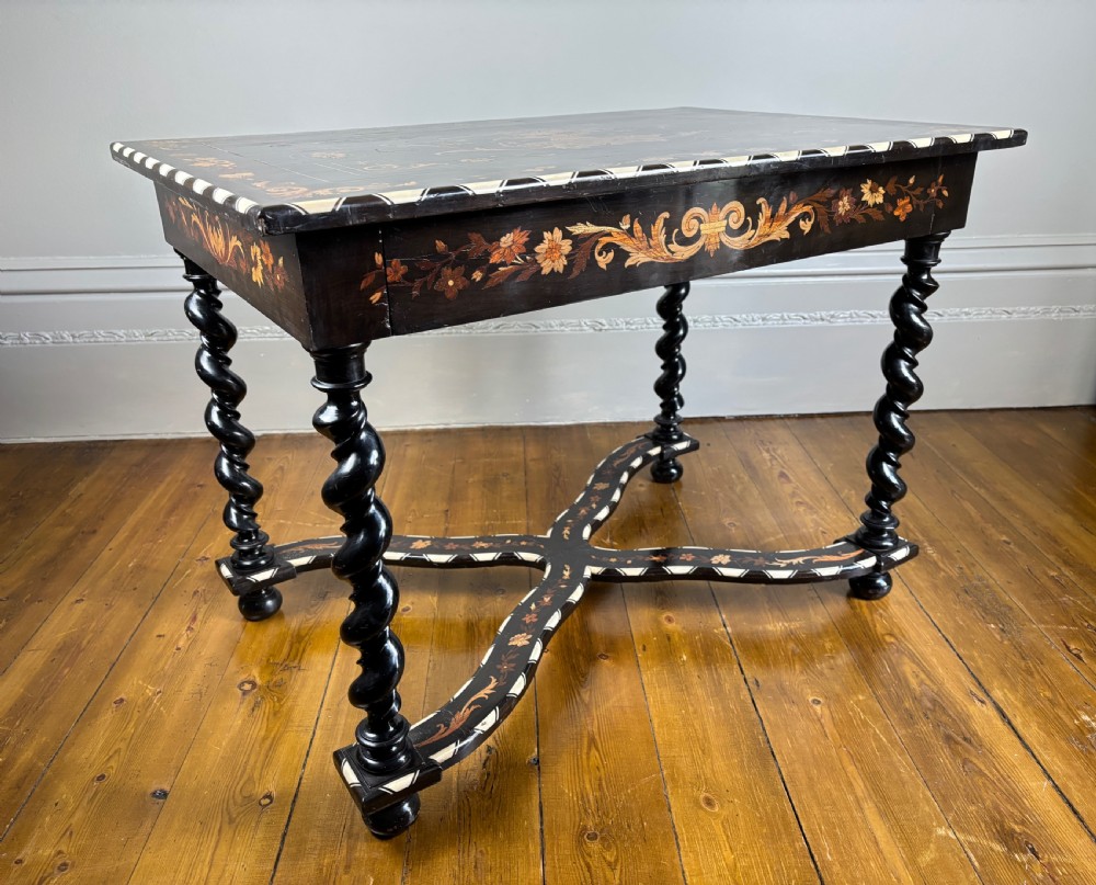 A 19th-century Dutch ebonised rectangular side table featuring floral marquetry, bone inlay borders, turned barley twist legs, and a shaped X-stretcher.