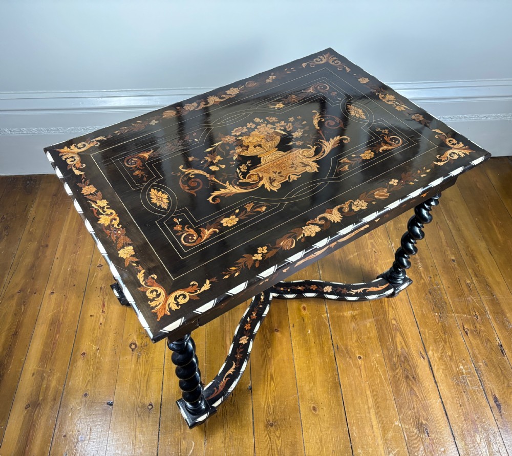 A 19th-century Dutch ebonised rectangular side table featuring floral marquetry, bone inlay borders, turned barley twist legs, and a shaped X-stretcher. View VII