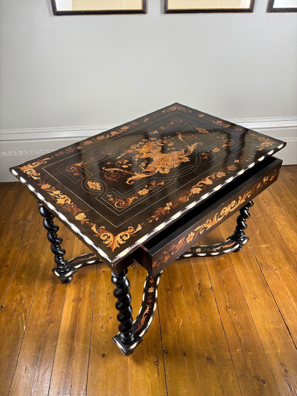 A 19th-century Dutch ebonised rectangular side table featuring floral marquetry, bone inlay borders, turned barley twist legs, and a shaped X-stretcher. View IX