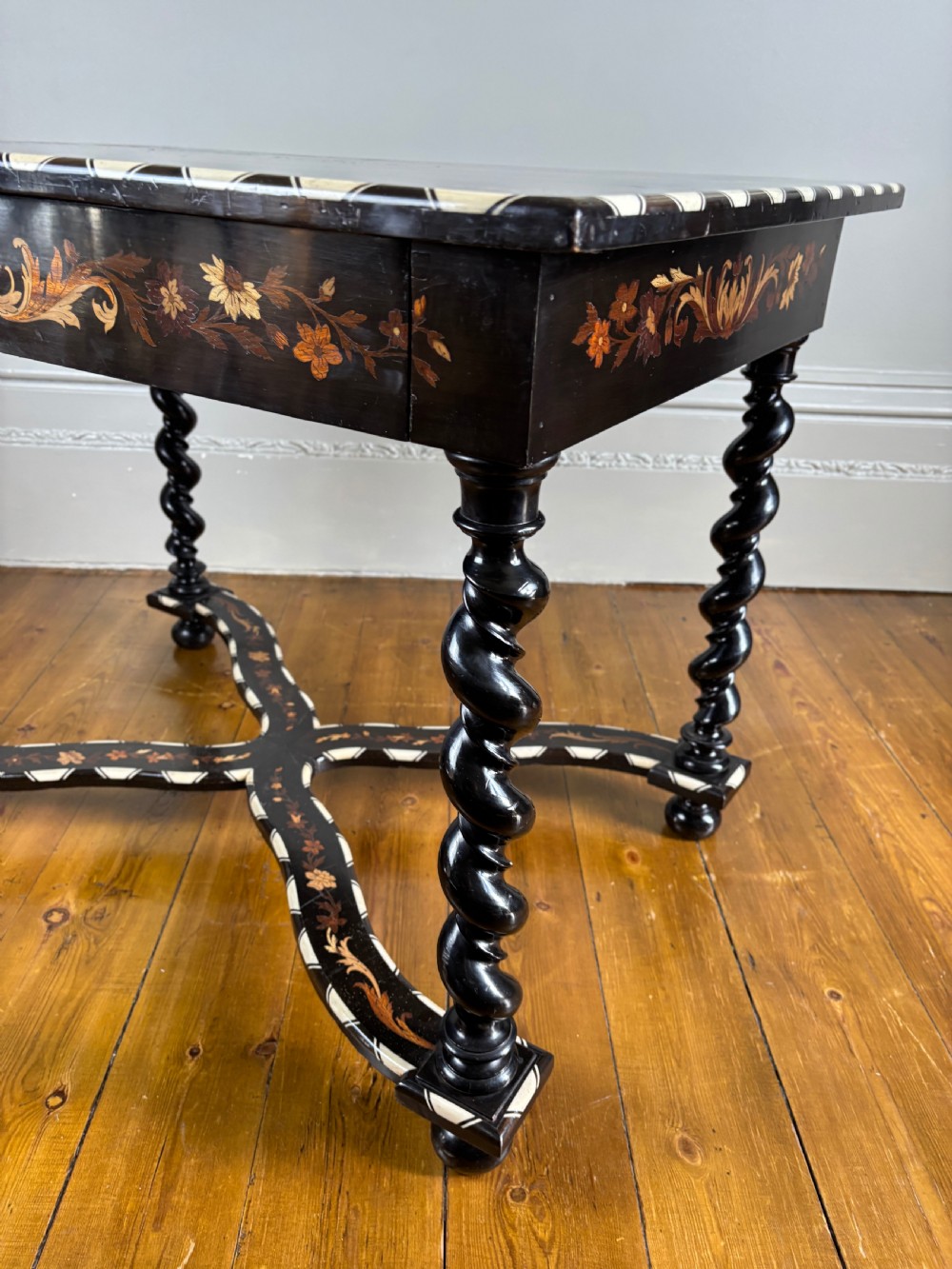 A 19th-century Dutch ebonised rectangular side table featuring floral marquetry, bone inlay borders, turned barley twist legs, and a shaped X-stretcher. View X