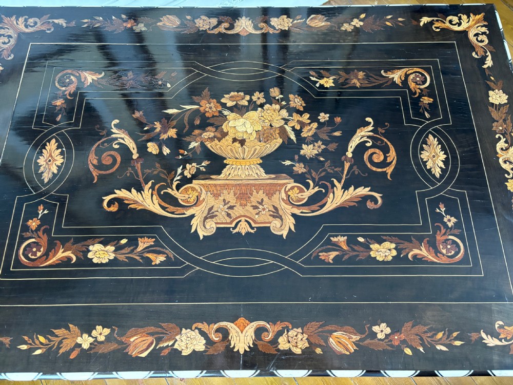 A 19th-century Dutch ebonised rectangular side table featuring floral marquetry, bone inlay borders, turned barley twist legs, and a shaped X-stretcher. View XII