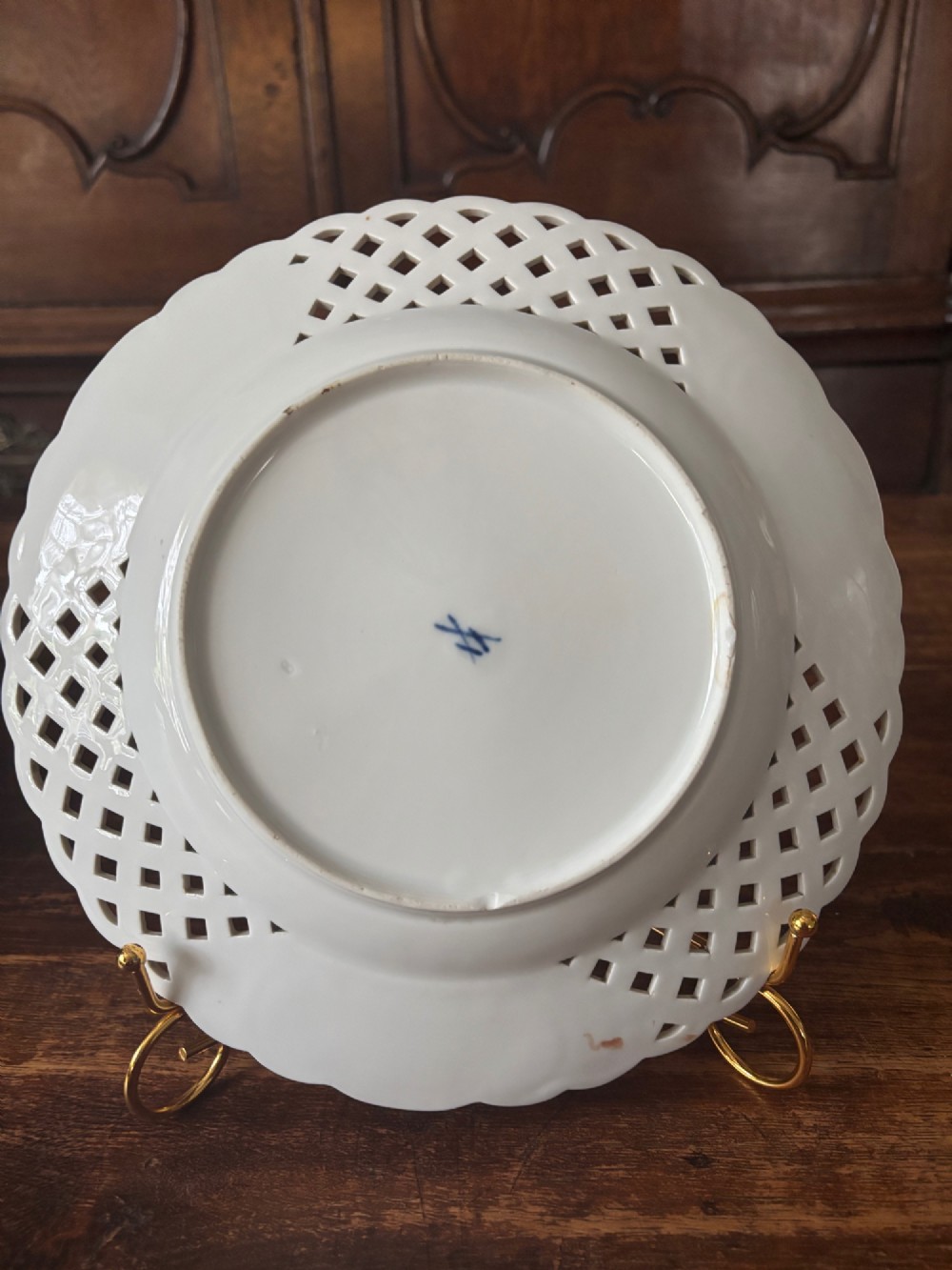 A circular Meissen porcelain cabinet plate featuring a reticulated openwork lattice rim accented with gilded cartouches and hand-painted exotic birds in the centre. View VII