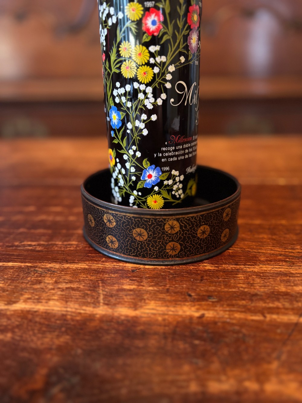 A circular black lacquered antique wine coaster decorated with gold star motifs and vermicelli patterns around the exterior side. View II