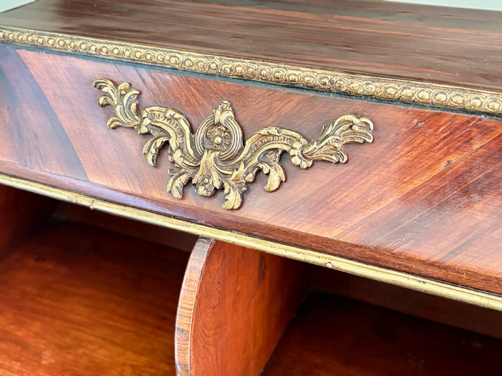 A Louis XV style rosewood desktop cartonnier with curved sides, gold-toned ormolu mounts, and open storage compartments. View II