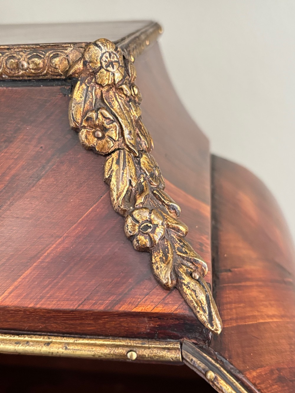 A Louis XV style rosewood desktop cartonnier with curved sides, gold-toned ormolu mounts, and open storage compartments. View III