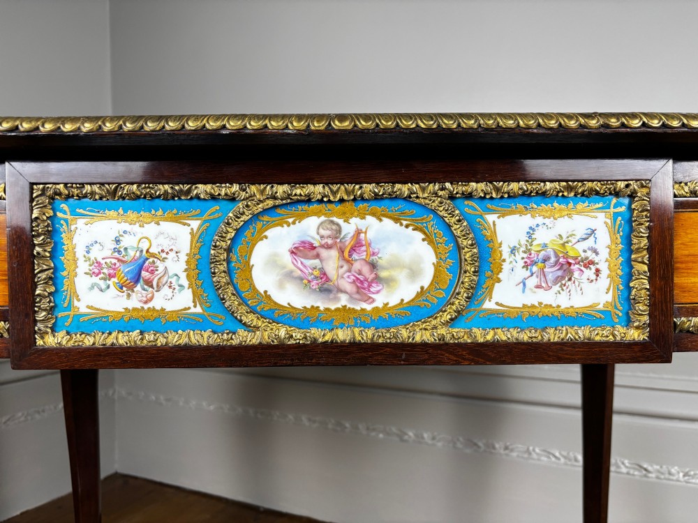 A Louis XV style rosewood writing table featuring cabriole legs, gilt bronze ormolu mounts, and turquoise porcelain plaques. View III