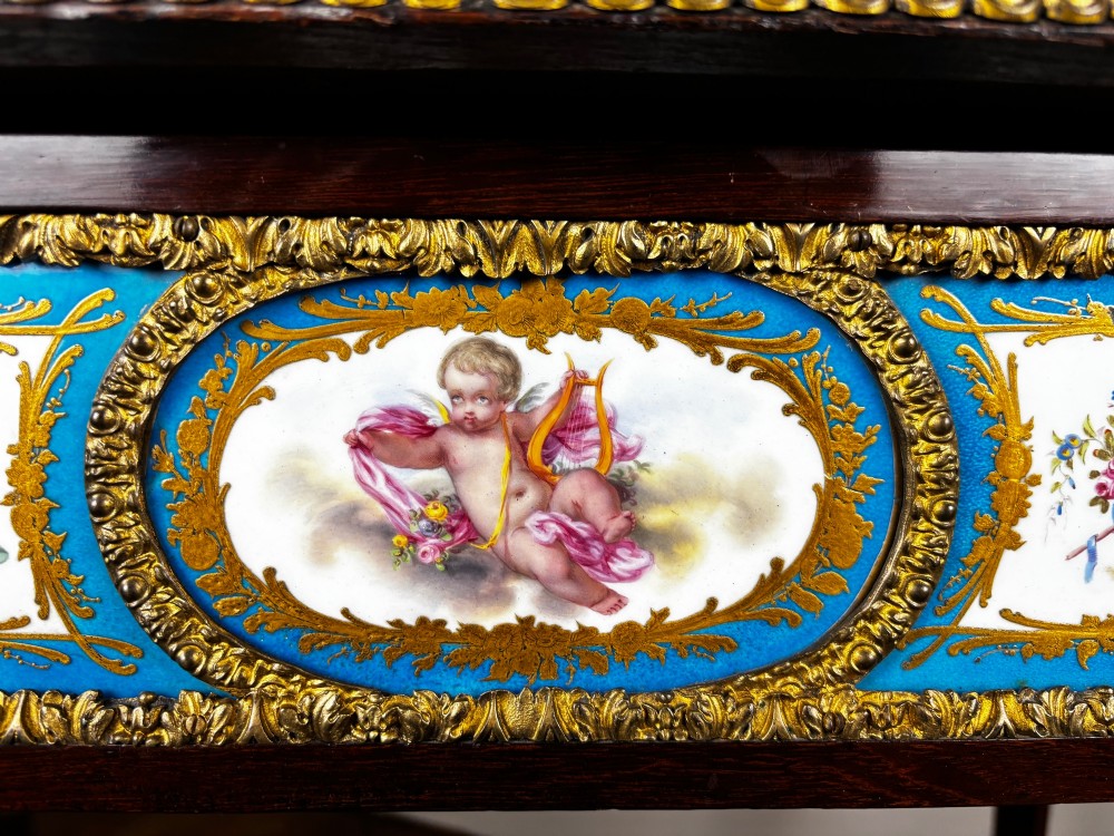 A Louis XV style rosewood writing table featuring cabriole legs, gilt bronze ormolu mounts, and turquoise porcelain plaques. View IV