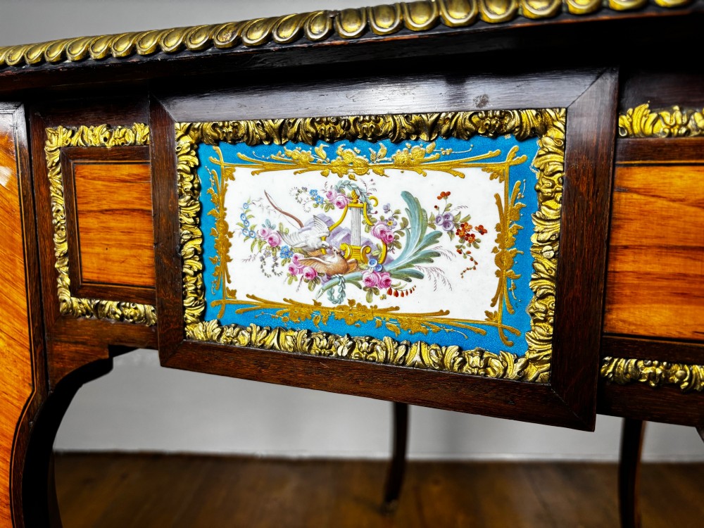 A Louis XV style rosewood writing table featuring cabriole legs, gilt bronze ormolu mounts, and turquoise porcelain plaques. View V