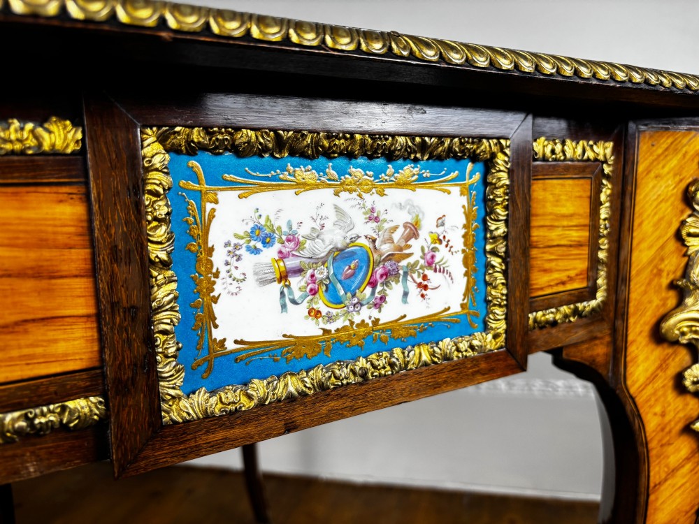 A Louis XV style rosewood writing table featuring cabriole legs, gilt bronze ormolu mounts, and turquoise porcelain plaques. View VI