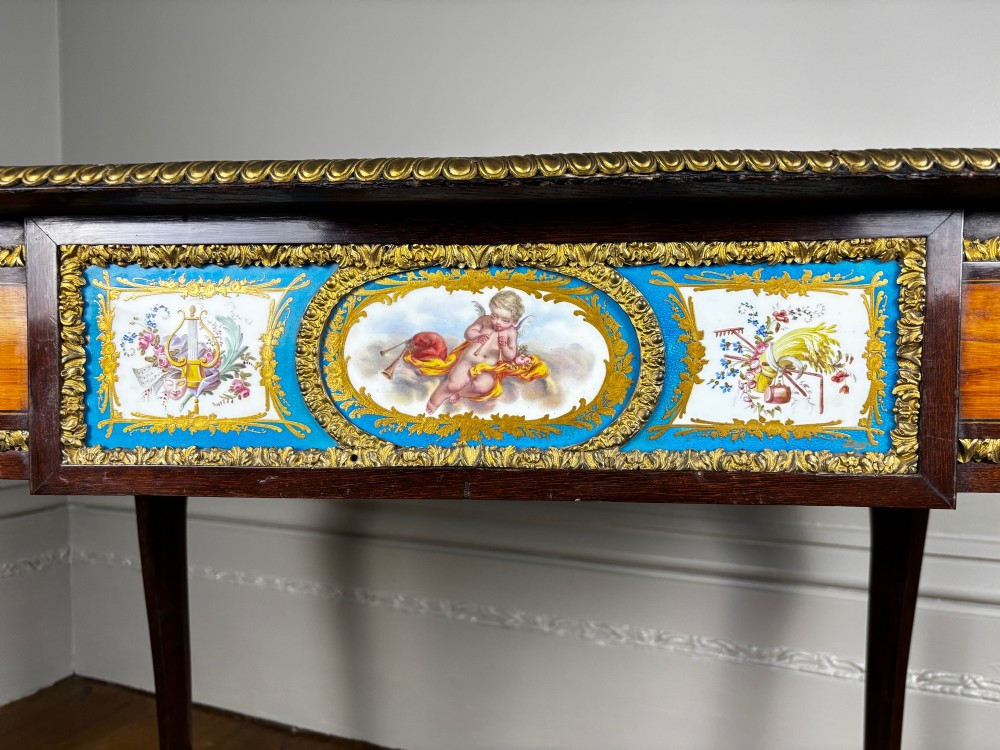 A Louis XV style rosewood writing table featuring cabriole legs, gilt bronze ormolu mounts, and turquoise porcelain plaques. View VII