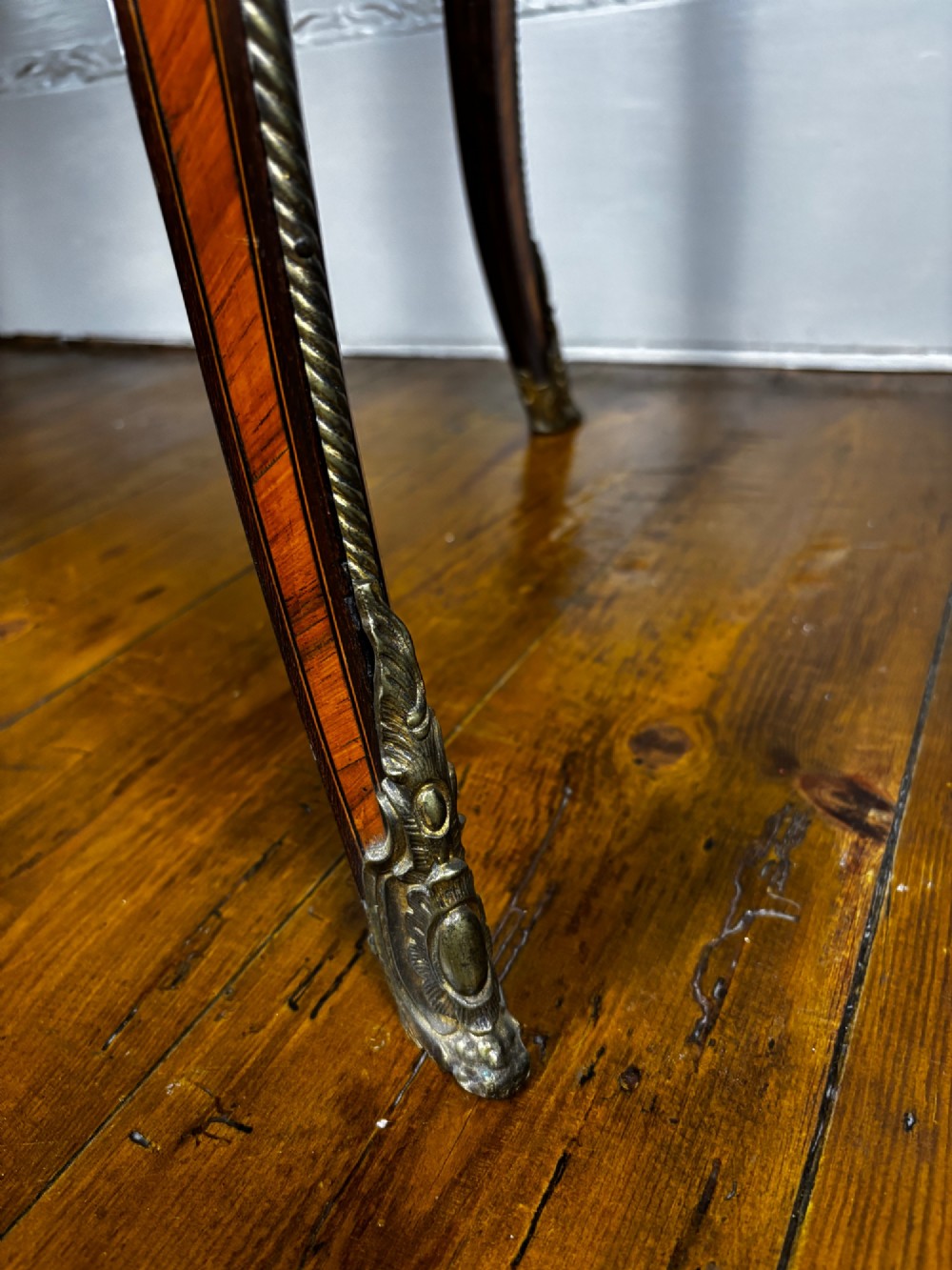 A Louis XV style rosewood writing table featuring cabriole legs, gilt bronze ormolu mounts, and turquoise porcelain plaques. View X