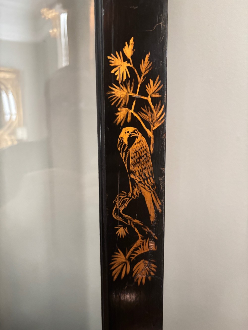 A four-fold black lacquered screen with Chinese Chippendale fretwork crestings, glazed upper panels, and incised gold chinoiserie landscape scenes. View IV