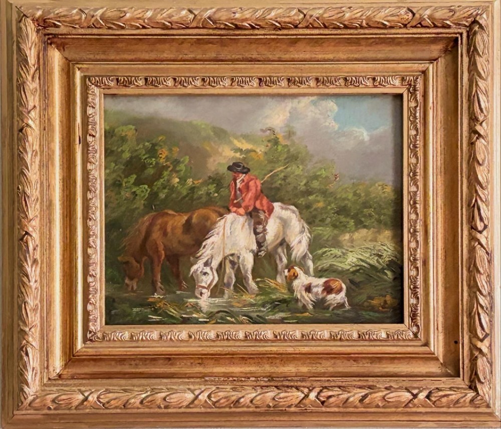 A framed Georgian oil painting on board depicting a man seated on a white horse alongside a brown horse drinking from a stream with a small dog nearby.