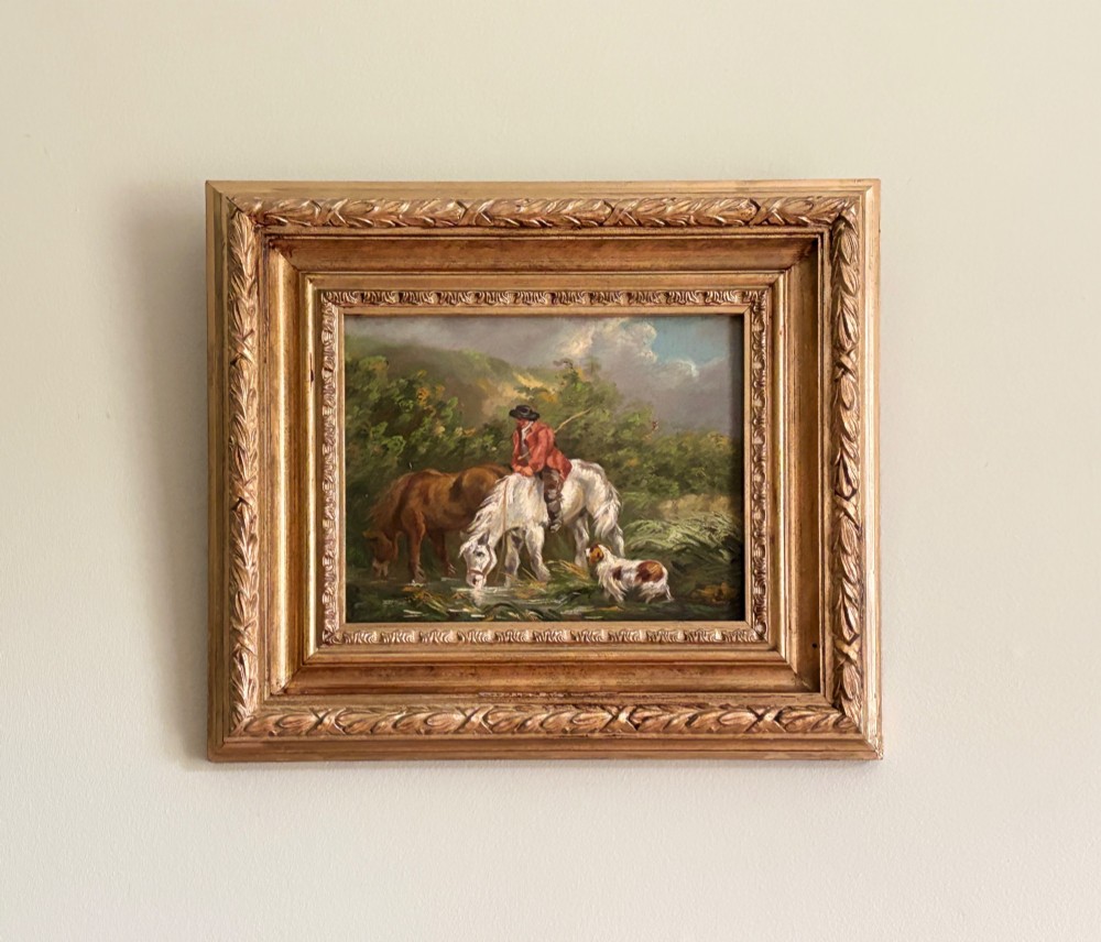 A framed Georgian oil painting on board depicting a man seated on a white horse alongside a brown horse drinking from a stream with a small dog nearby. View VII