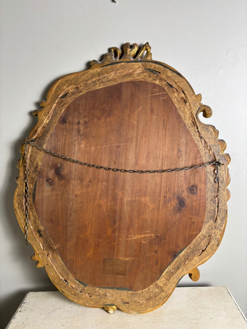 An oval Edwardian portrait of a young boy in a white sailor collar with a navy blue bow, set within a carved giltwood scroll frame. View VII