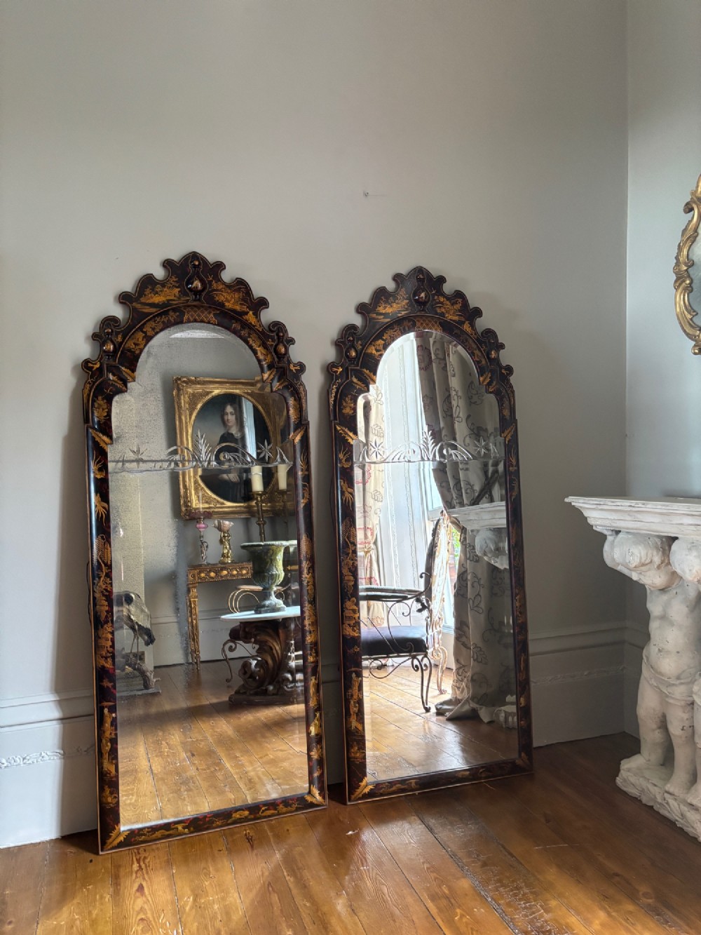 A pair of tall arched Queen Anne style pier mirrors featuring black lacquered frames decorated with gilded chinoiserie motifs and star-etched glass upper panels. View III