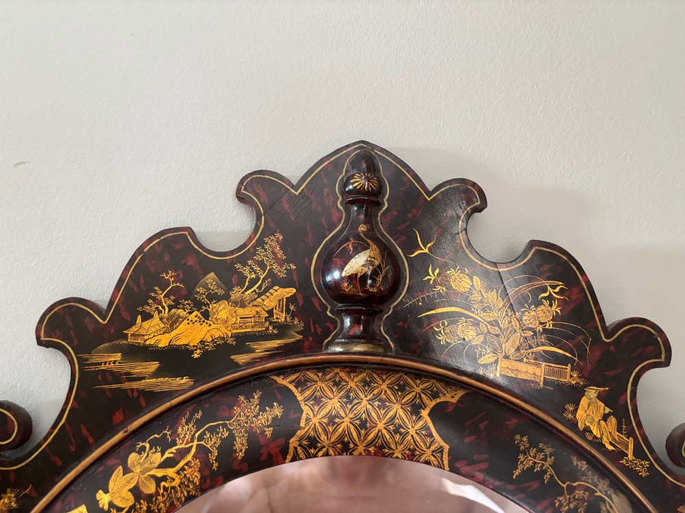 A pair of tall arched Queen Anne style pier mirrors featuring black lacquered frames decorated with gilded chinoiserie motifs and star-etched glass upper panels. View IV
