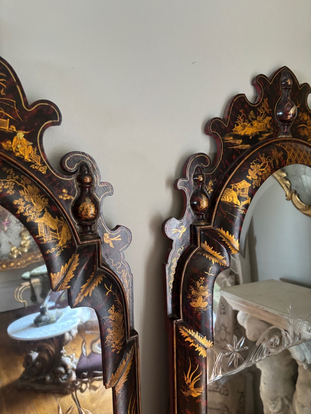 A pair of tall arched Queen Anne style pier mirrors featuring black lacquered frames decorated with gilded chinoiserie motifs and star-etched glass upper panels. View VI