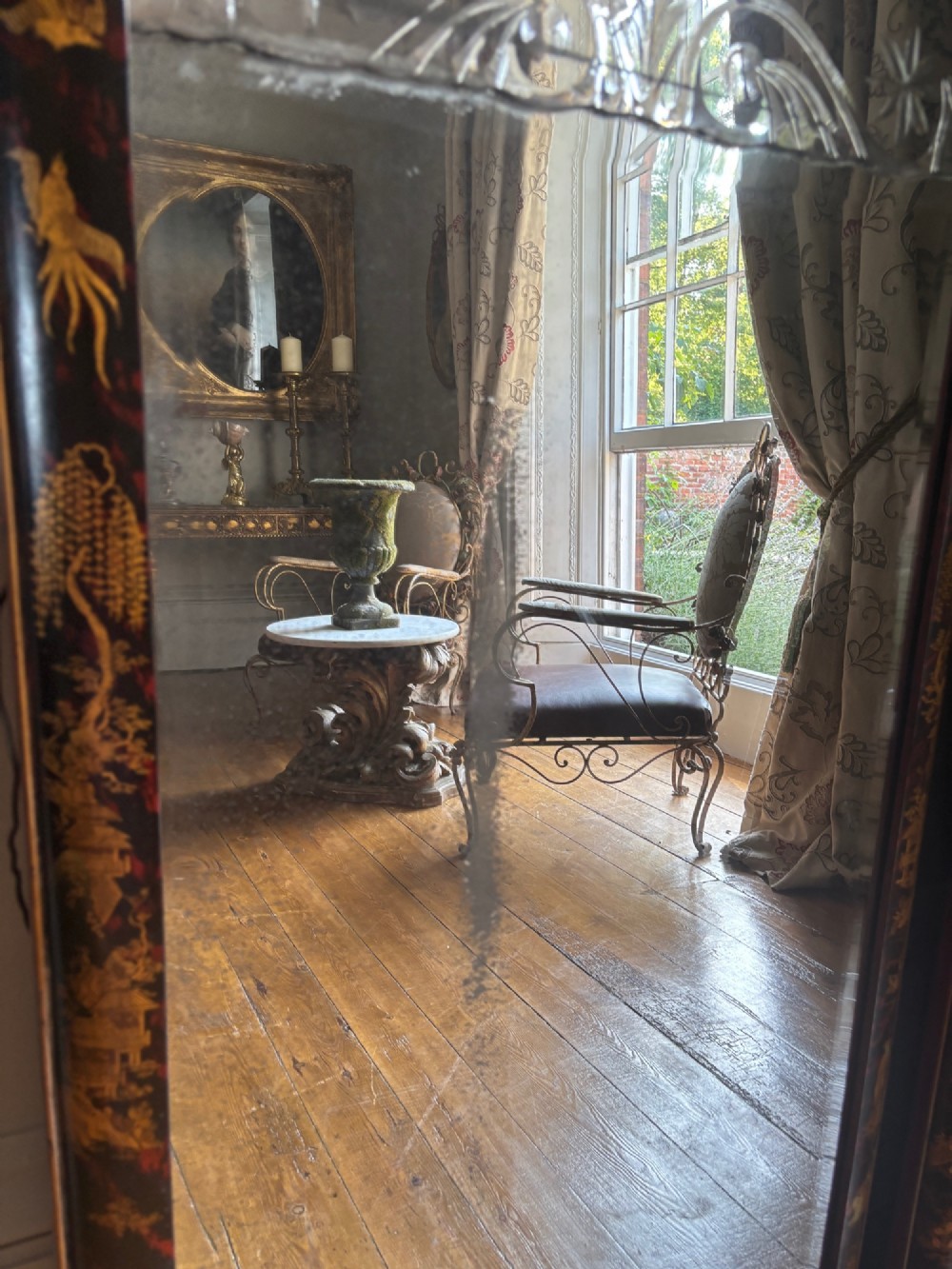 A pair of tall arched Queen Anne style pier mirrors featuring black lacquered frames decorated with gilded chinoiserie motifs and star-etched glass upper panels. View VII