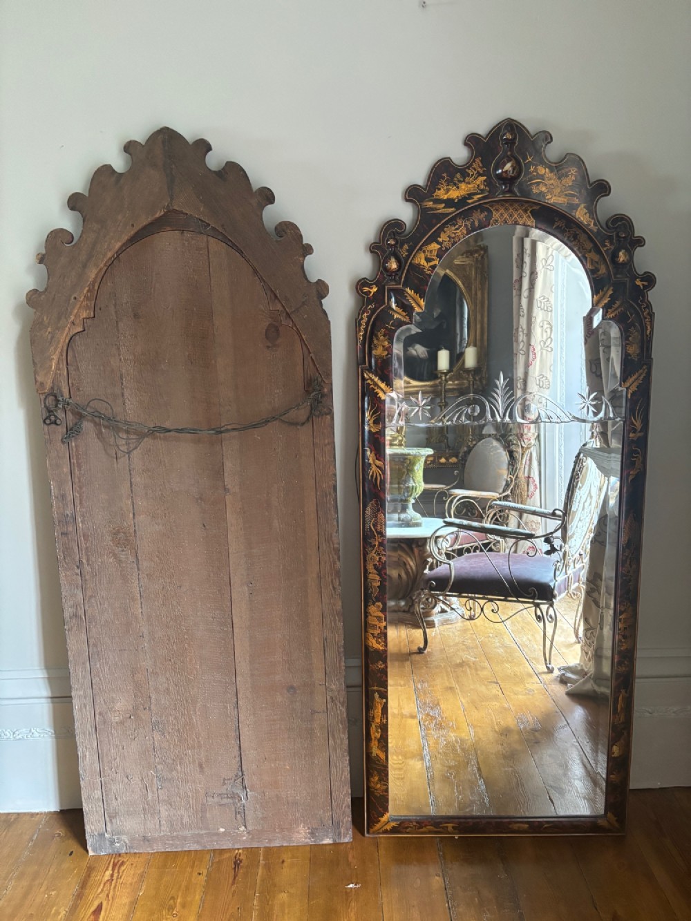A pair of tall arched Queen Anne style pier mirrors featuring black lacquered frames decorated with gilded chinoiserie motifs and star-etched glass upper panels. View IX