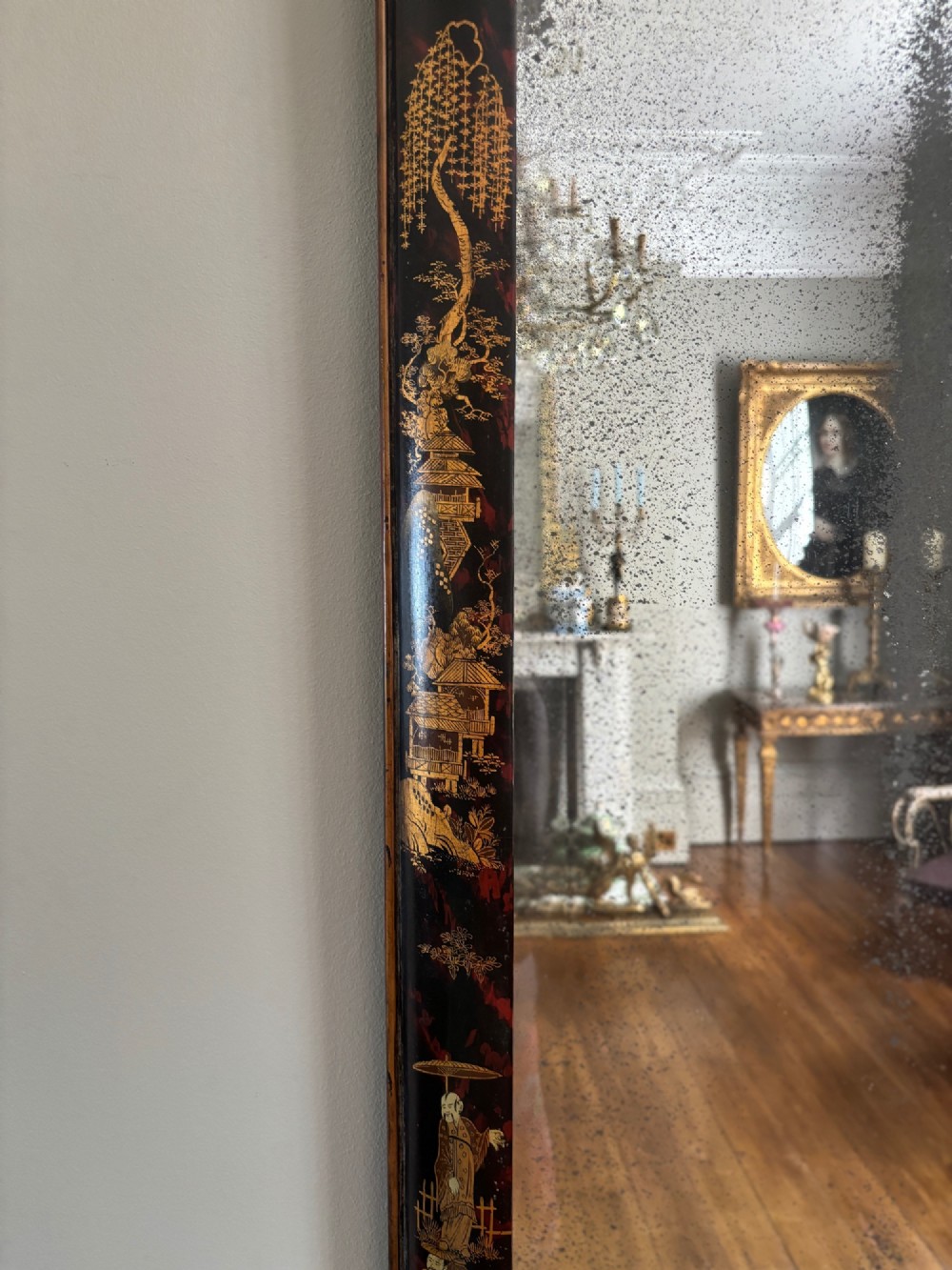 A pair of tall arched Queen Anne style pier mirrors featuring black lacquered frames decorated with gilded chinoiserie motifs and star-etched glass upper panels. View XI