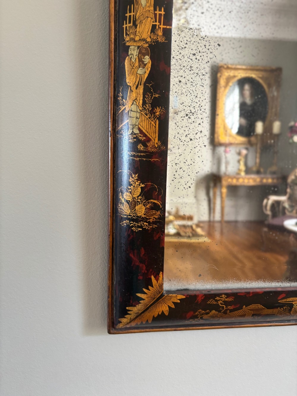 A pair of tall arched Queen Anne style pier mirrors featuring black lacquered frames decorated with gilded chinoiserie motifs and star-etched glass upper panels. View XII