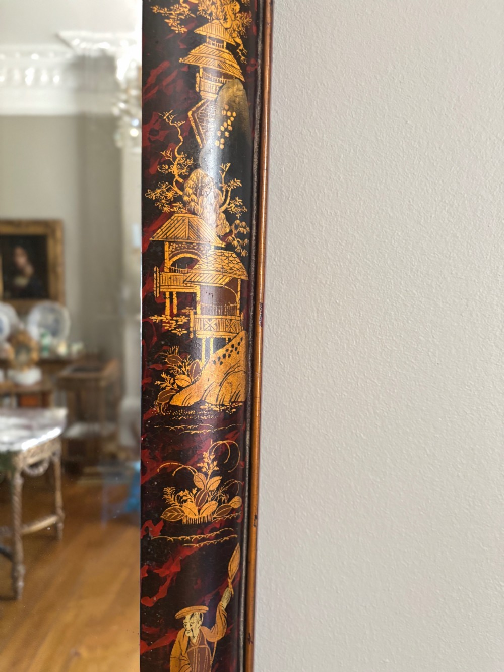 A pair of tall arched Queen Anne style pier mirrors featuring black lacquered frames decorated with gilded chinoiserie motifs and star-etched glass upper panels. View XIII