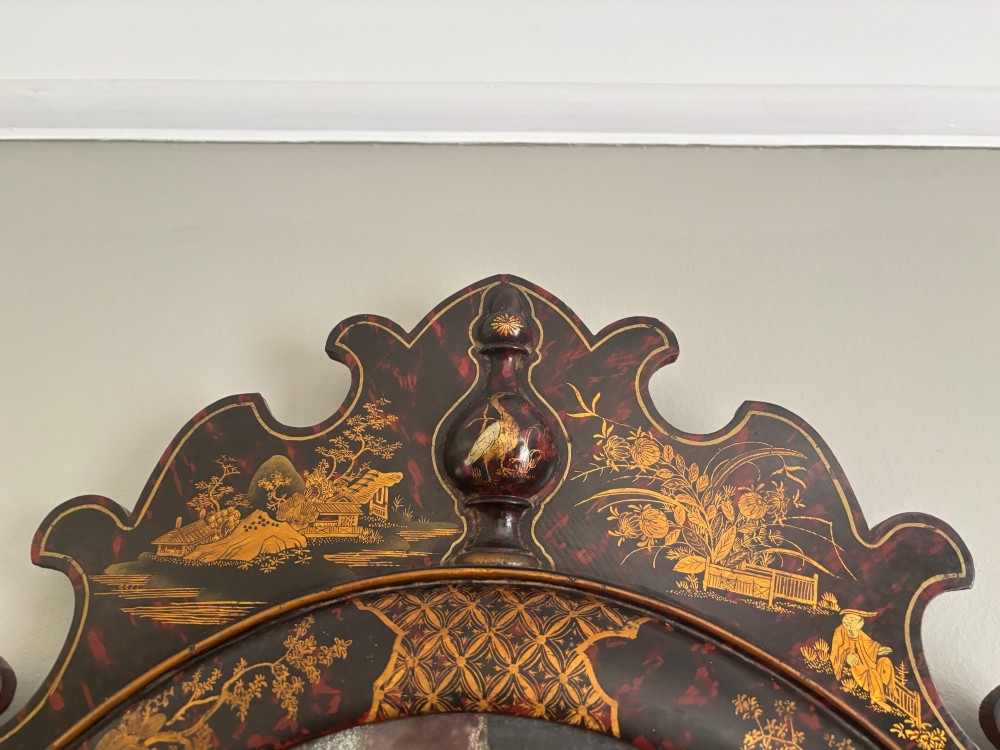 A pair of tall arched Queen Anne style pier mirrors featuring black lacquered frames decorated with gilded chinoiserie motifs and star-etched glass upper panels. View XV