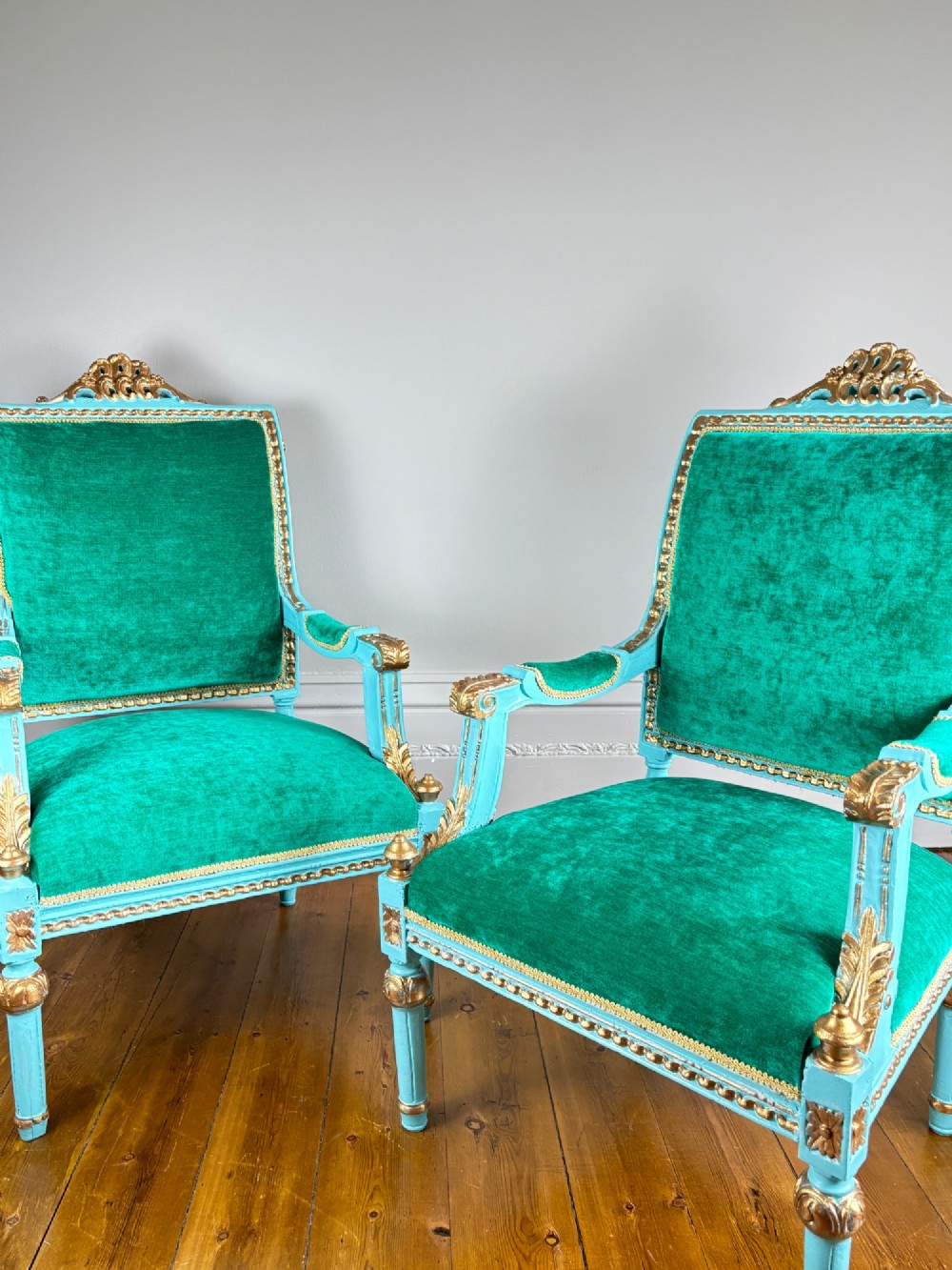 A pair of mid-19th-century French open armchairs featuring turquoise painted frames with gold gilt detailing and emerald green velvet upholstery. View V