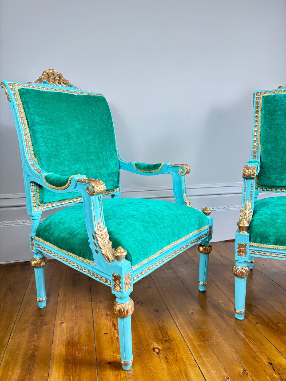 A pair of mid-19th-century French open armchairs featuring turquoise painted frames with gold gilt detailing and emerald green velvet upholstery. View VII