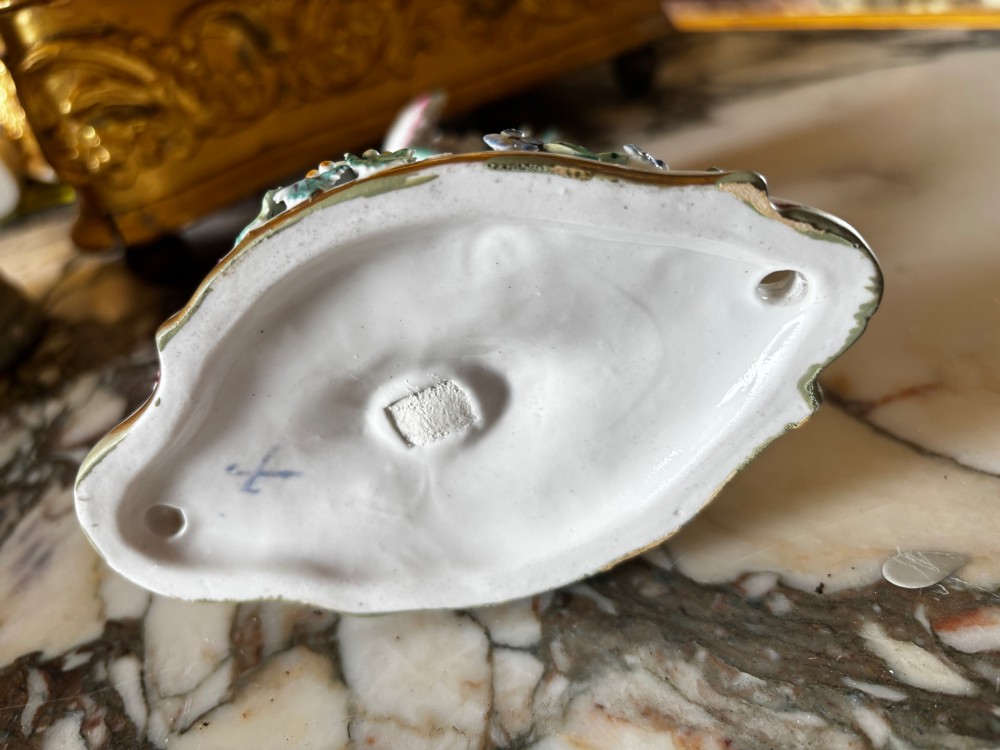 An antique Meissen hard-paste porcelain single candle wall sconce decorated with applied colourful flowers, gilt rococo scrollwork backplate, and a petal-shaped candle socket. View VII