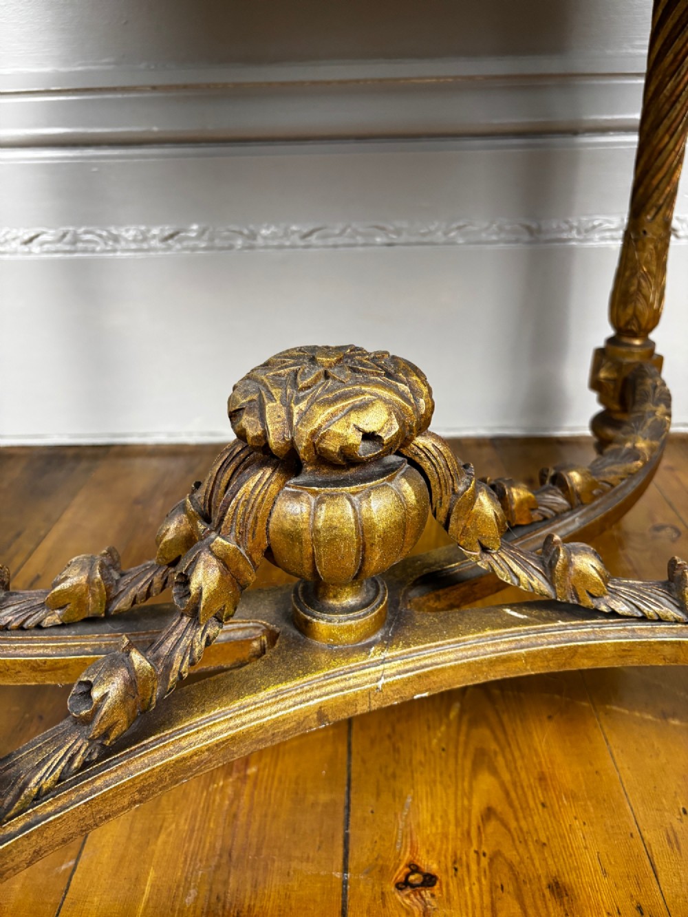 An early 20th-century French Louis XV Revival giltwood console table with a carved openwork apron, spiralled legs, curved stretcher, and fitted white marble top. View V
