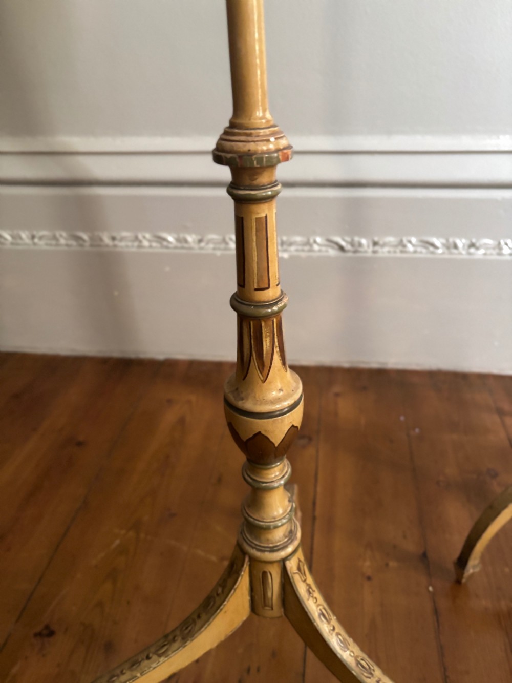 A pair of antique Georgian cream painted Hepplewhite pole screens featuring central oval vignettes depicting classical female figures with floral surround details on tripod spade-foot bases. View V
