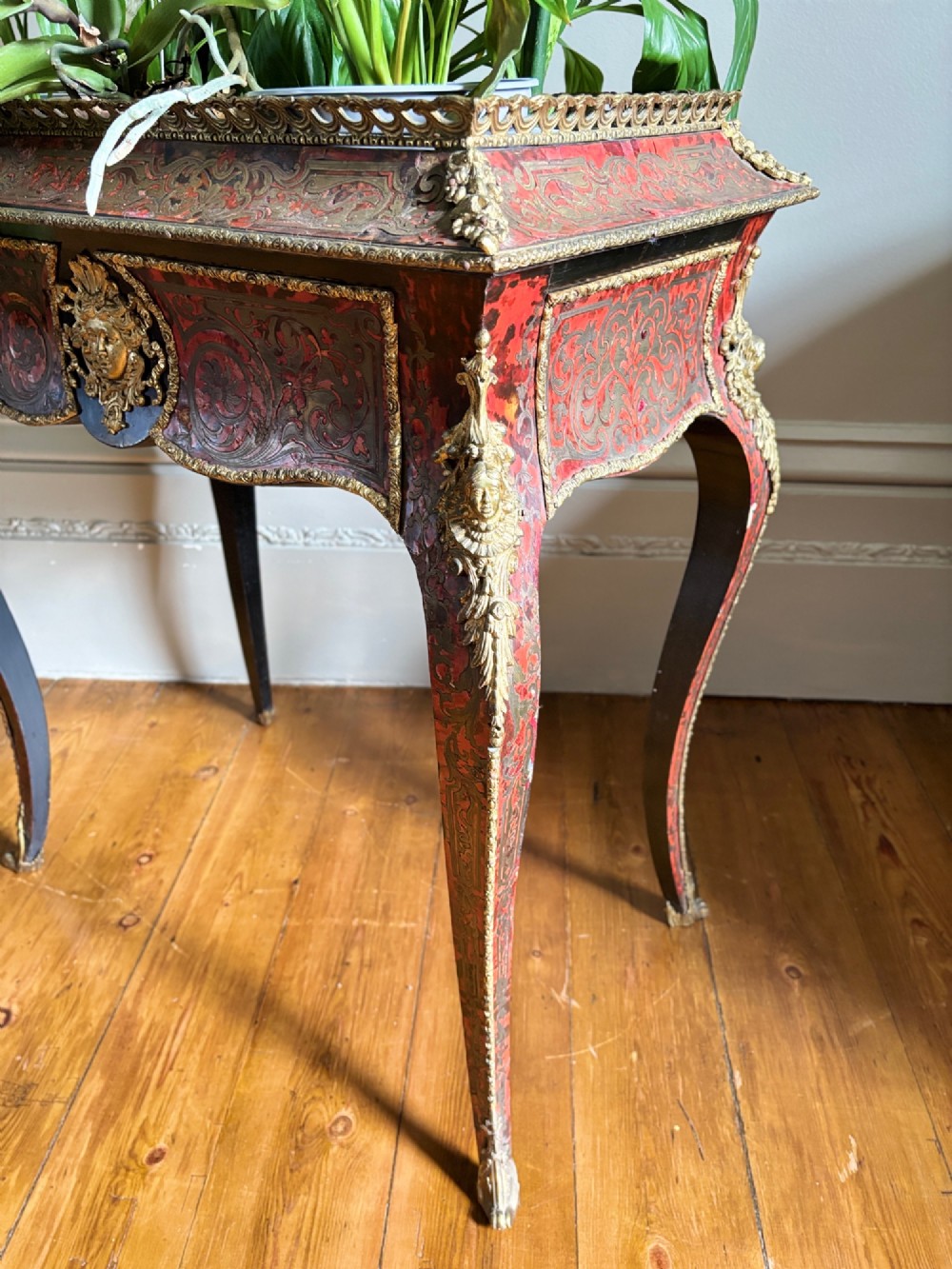 A 19th-century French Napoleon III jardiniere stand featuring red tortoiseshell and brass marquetry inlay, gilt bronze mounts, and curved cabriole legs. View XI