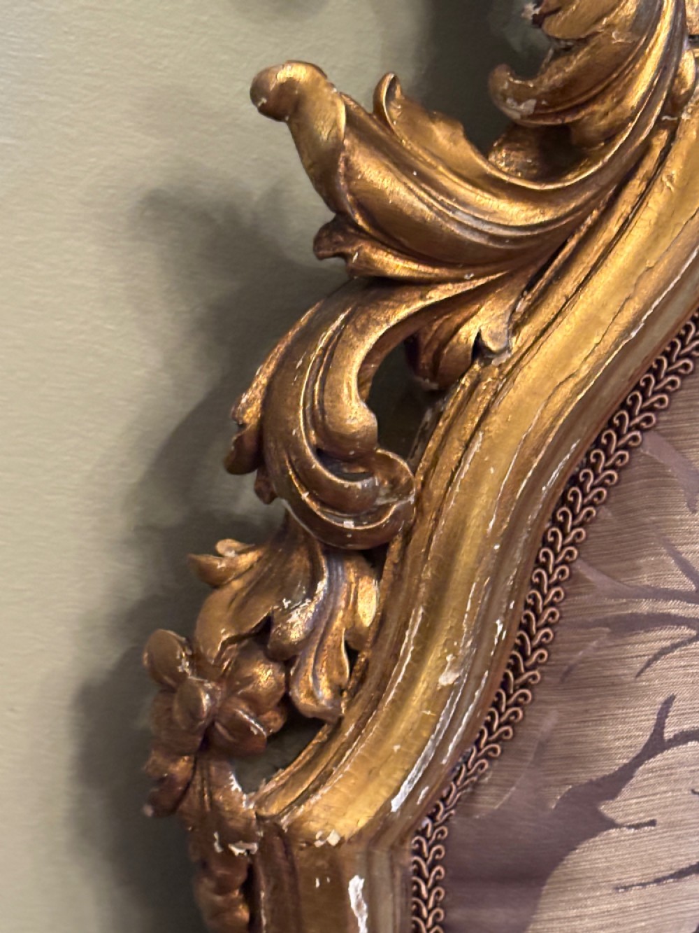 A 19th-century Italian Rococo giltwood bed frame with an ornate carved headboard and footboard upholstered in patterned damask fabric. View VII
