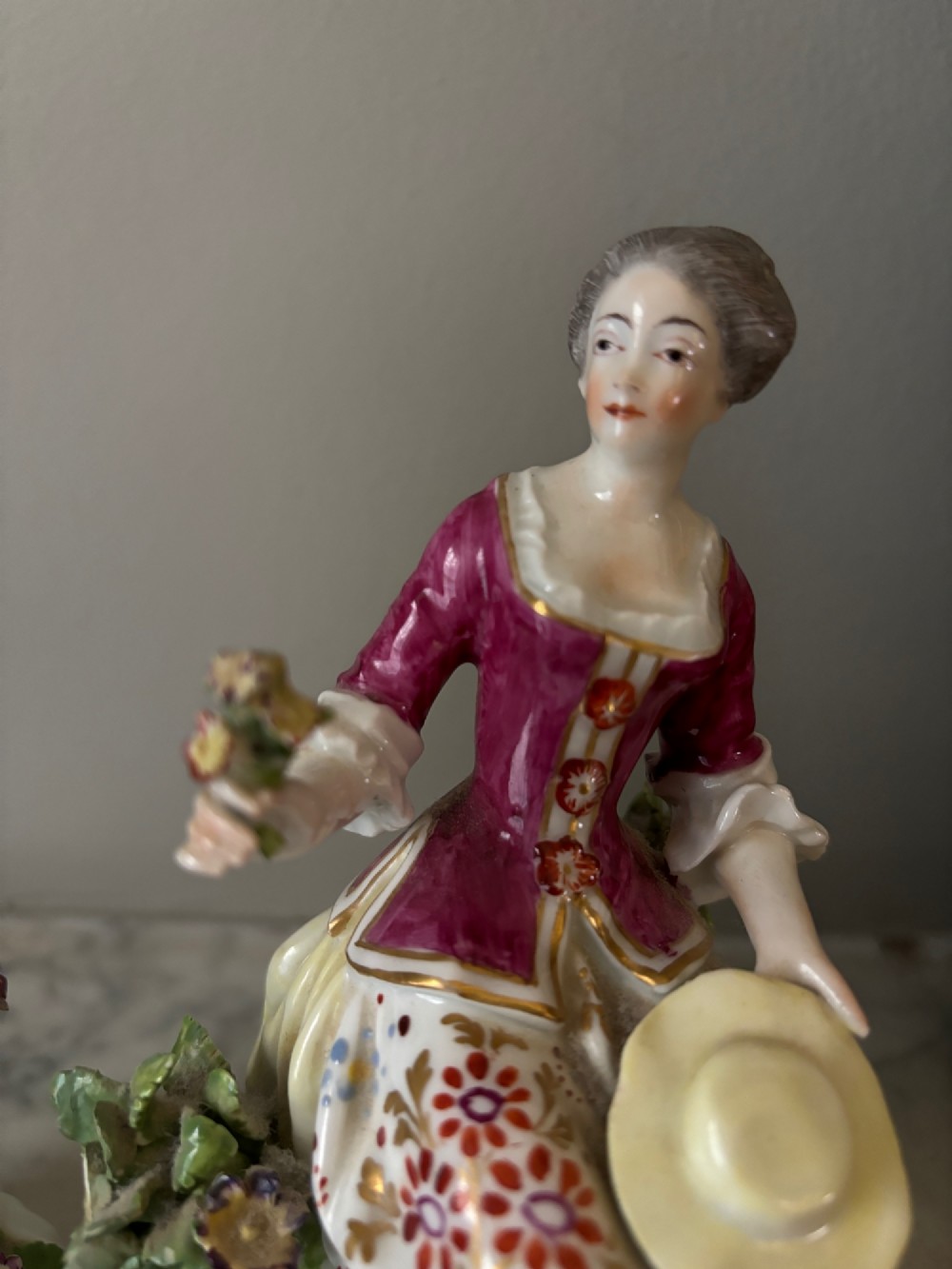 A pair of 19th-century Edme Samson hard-paste porcelain figurines depicting an 18th-century courtly man and woman in colourful enamelled attire seated on gilded rococo scroll bases. View III