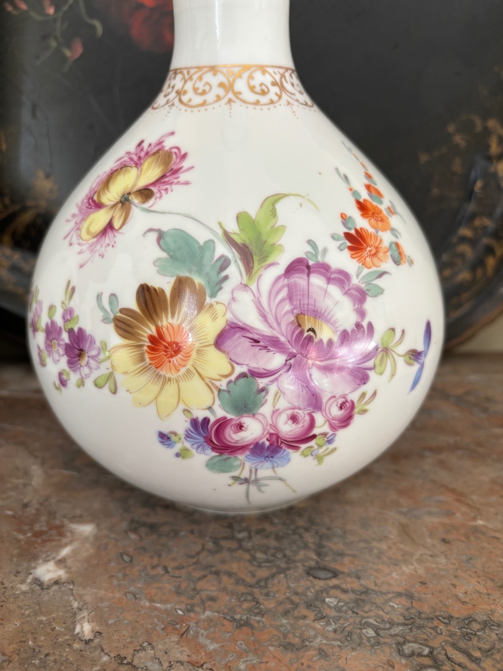 A pair of white 19th-century Sitzendorf porcelain covered vases featuring slender necks, bulbous bodies, hand-painted floral motifs, and gilded accents. View II